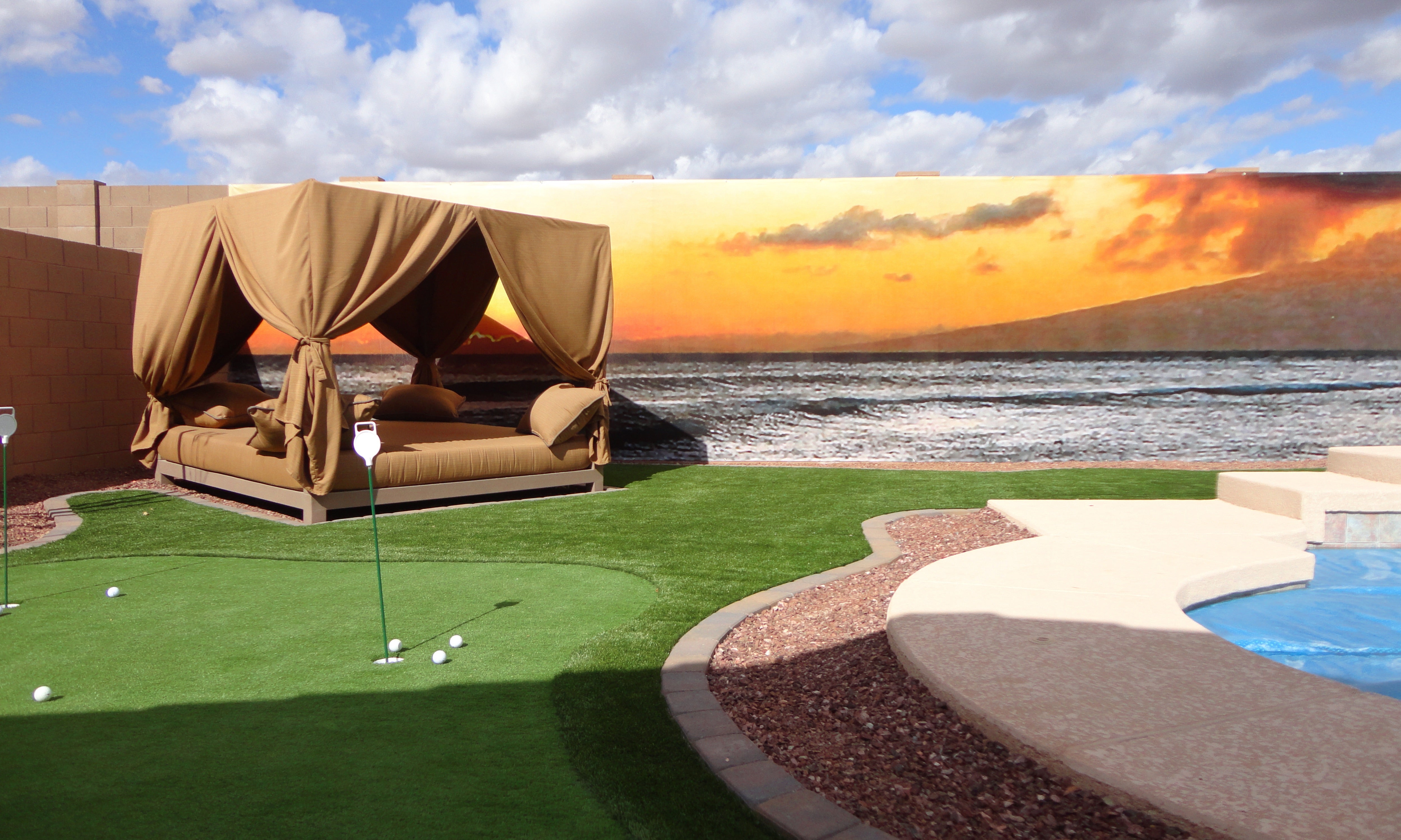 Residential Backyard Golf Putting Green with Ocean Sunset Outdoor Wall Mural