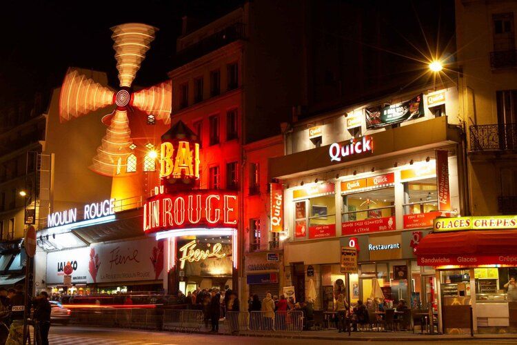 Moulin Rouge mural at night with glowing windmill, ideal for indoor and outdoor spaces.
