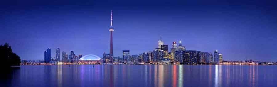 Toronto skyline mural at dusk with illuminated buildings, ideal for indoor and outdoor spaces.