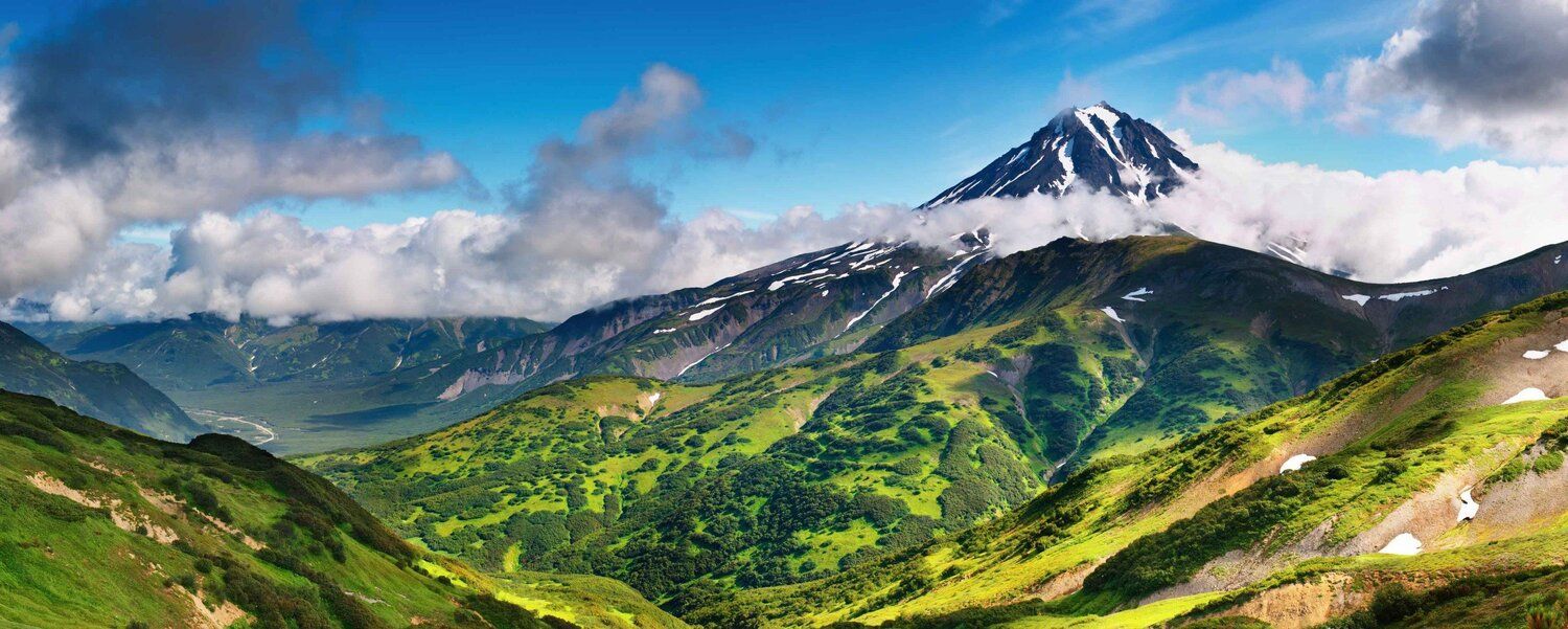 Snow-capped mountain mural with extinct volcano and clouds, ideal for indoor and outdoor spaces.
