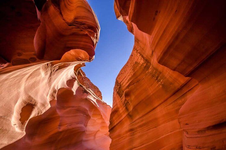 Antelope Canyon mural with red rocks framing a blue sky, ideal for indoor and outdoor spaces.