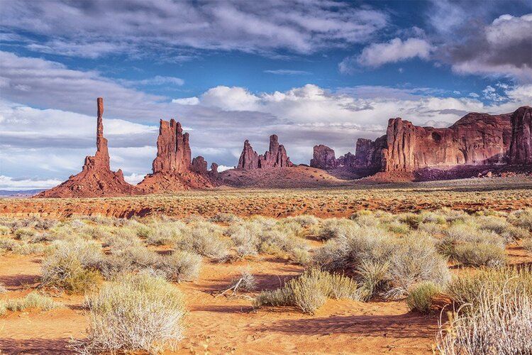 Monument Valley mural with clouds and rock formations, perfect for indoor and outdoor spaces.