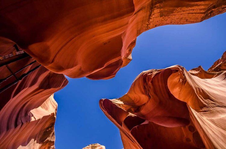 Antelope Canyon mural with red rock formations and blue sky, ideal for indoor and outdoor spaces.