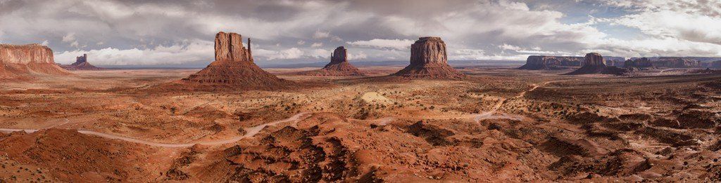 Panoramic mural of Monument Valley's red-sand desert, ideal for indoor and outdoor spaces.