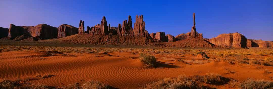 Monument Valley sunrise mural with Yei Bi Chei, Totem Pole, and sand dunes.