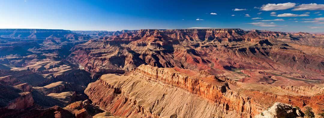Panoramic mural of Grand Canyon's layered rock formations, ideal for indoor and outdoor spaces.