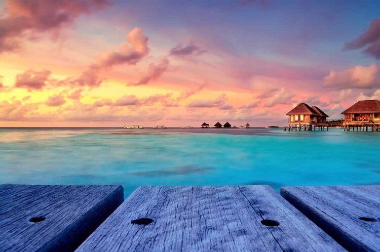 Maldivian sunset mural with warm glow over turquoise waters, ideal for indoor and outdoor spaces.