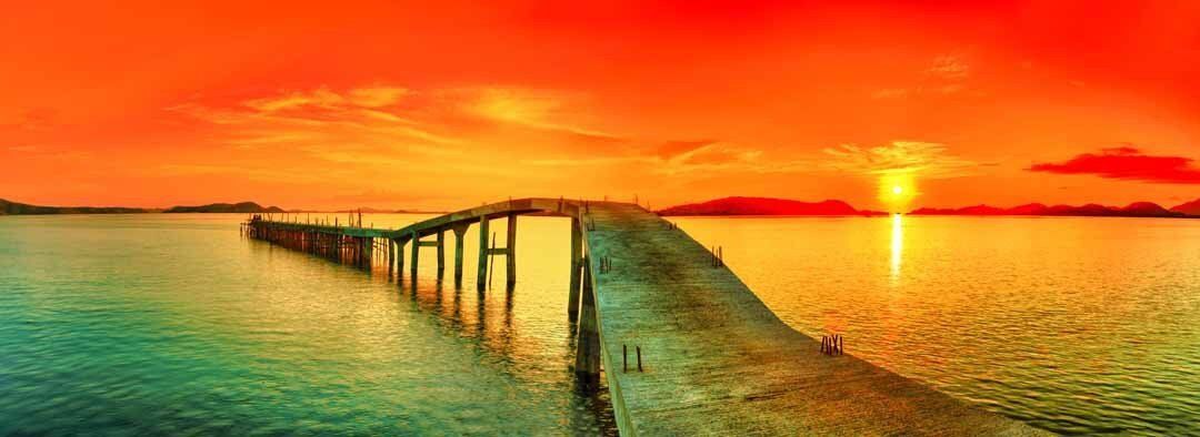 Panoramic mural of sunset over the sea with pier, ideal for tranquil indoor or outdoor spaces.