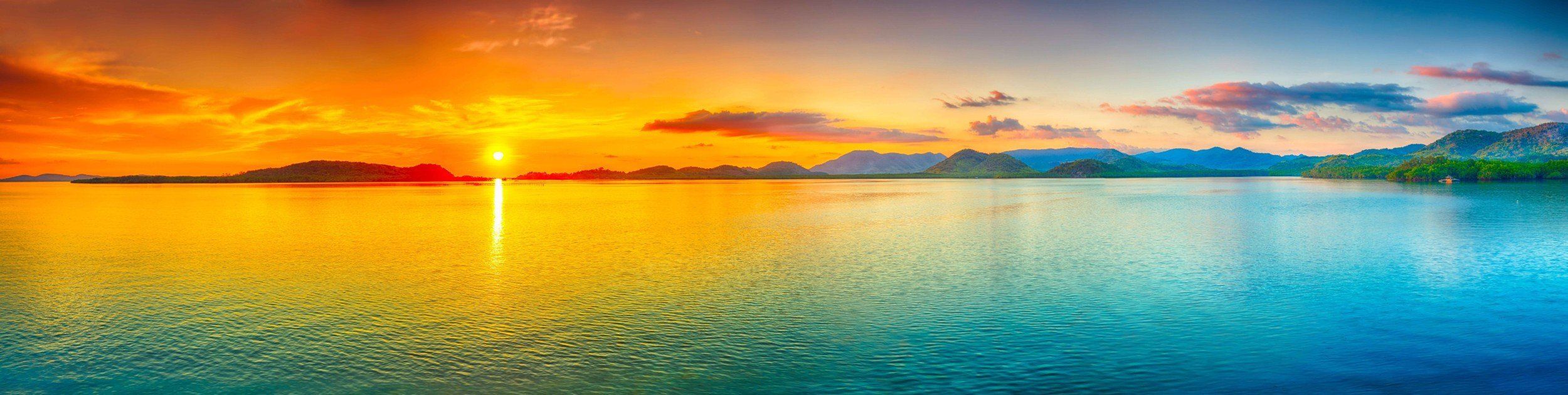 Panoramic sunrise over calm sea, ideal for creating a serene indoor or outdoor space.