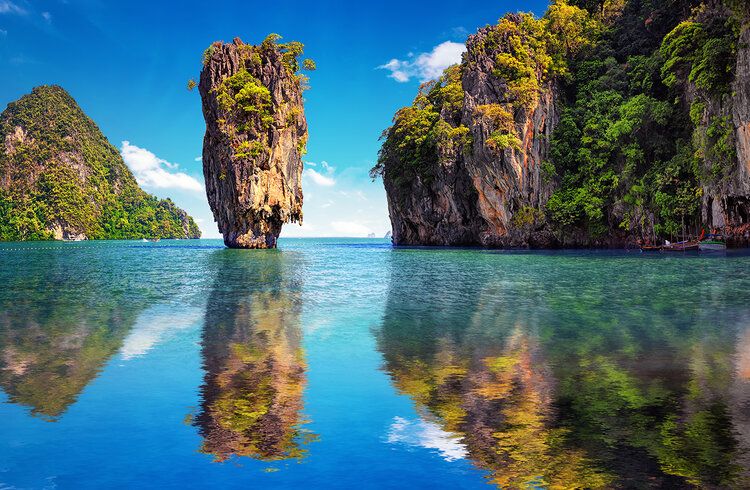 James Bond Island in Phuket, Thailand with cliffs, greenery, and calm waters in a scenic landscape.