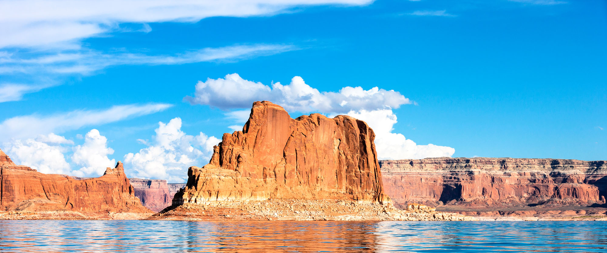 Panoramic Lake Powell mural with blue waters and rock formations, ideal for indoor and outdoor spaces.