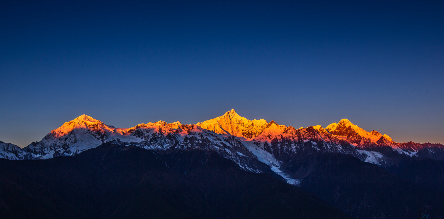 Panoramic mural of Meili Snow Mountain with golden sunlight, ideal for indoor and outdoor spaces.
